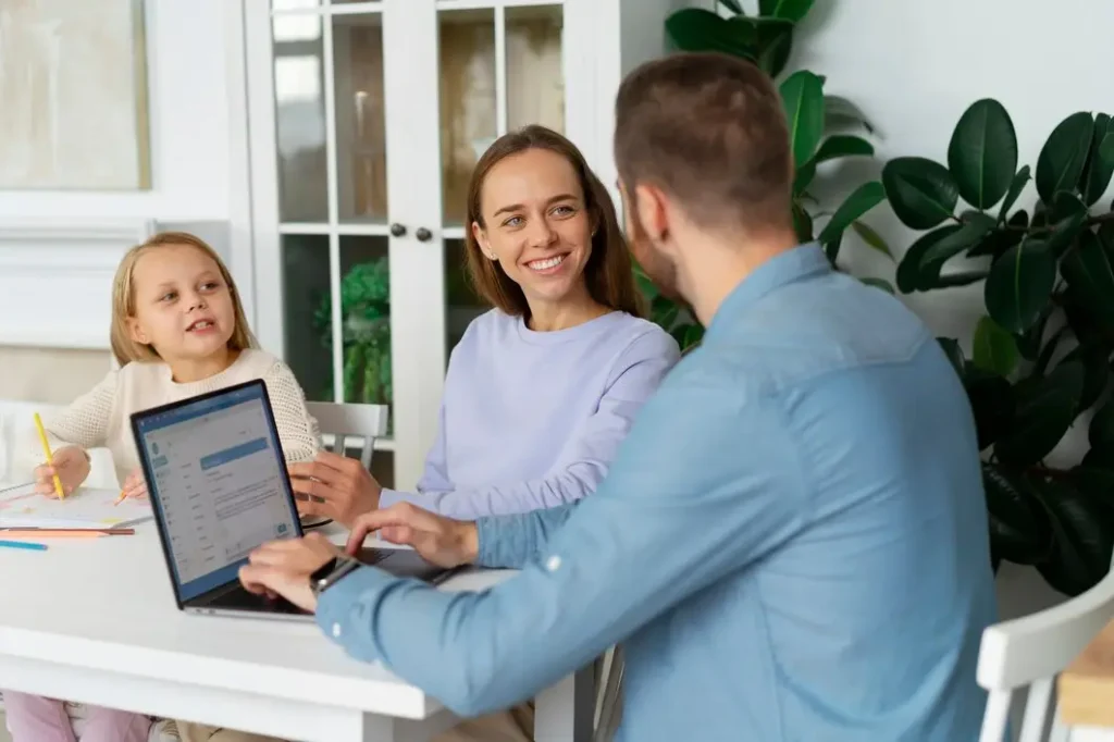 Woman and child discussing family law matters with a man using a laptop, emphasizing legal guidance in a home setting.