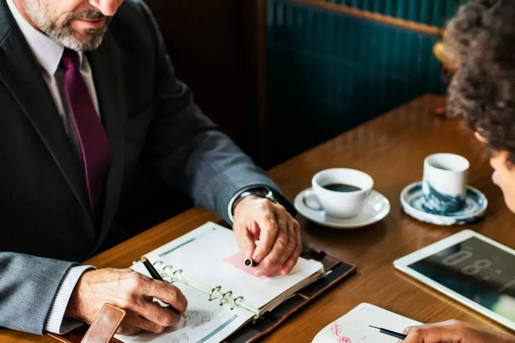 Professional lawyer consulting with a client over legal documents and coffee, emphasizing family law appeals in Bryker Woods.