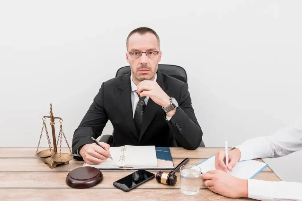 Lawyer consulting with a client, legal scales and gavel on desk, focused on family law appeals in Dell Parmer South Campus.