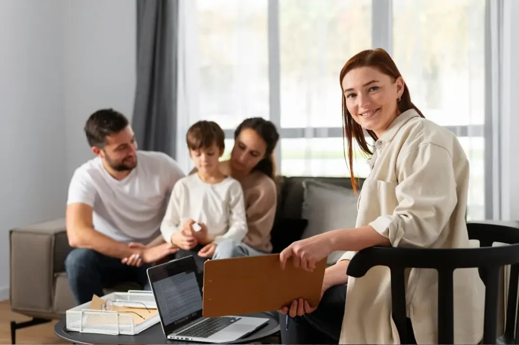 Smiling woman holding a clipboard in a living room with a family, representing legal support for tenant rights in Garland, Texas.