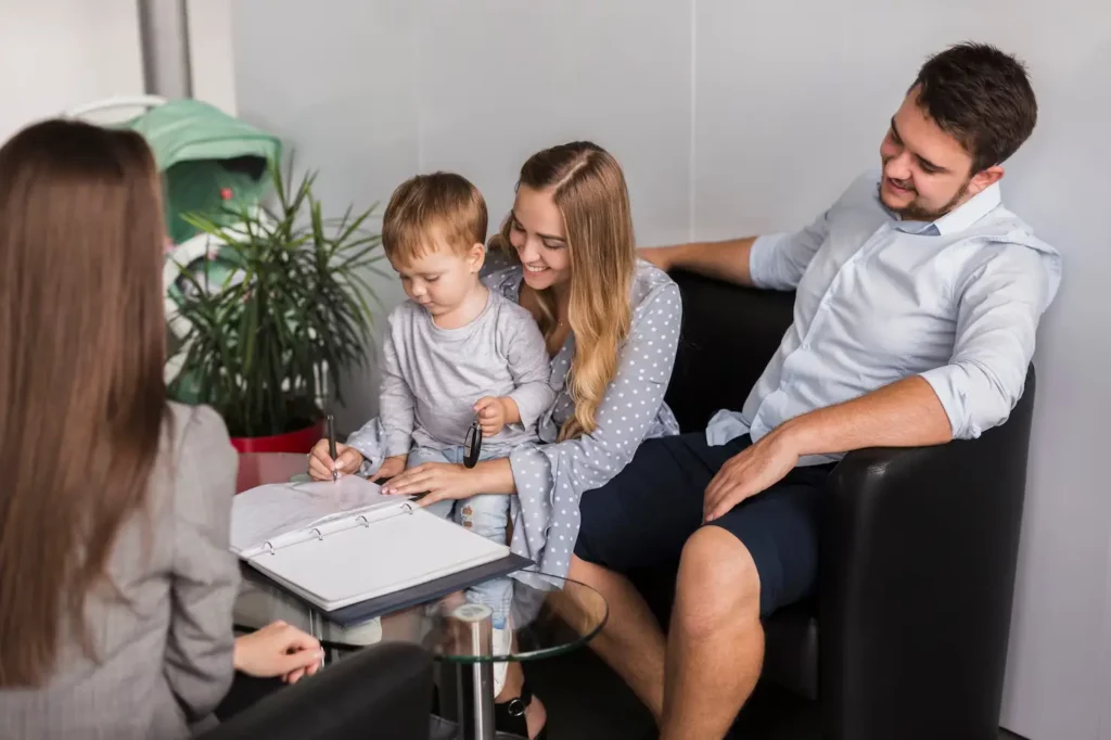 Family law consultation in Kingwood, Texas, featuring a mother, father, and child discussing legal documents with an attorney, emphasizing support in custody and family disputes.