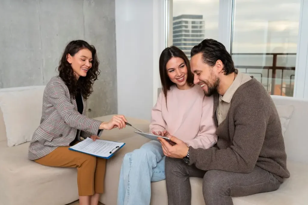 Woman discussing family law appeals with couple, reviewing documents on tablet in modern office setting.