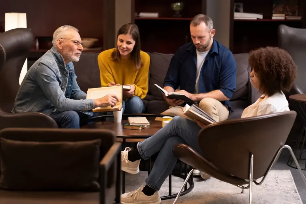 Group of four adults discussing family law appeals in a cozy setting, with books and notes on a coffee table, reflecting collaboration and support for McKinney family law issues.