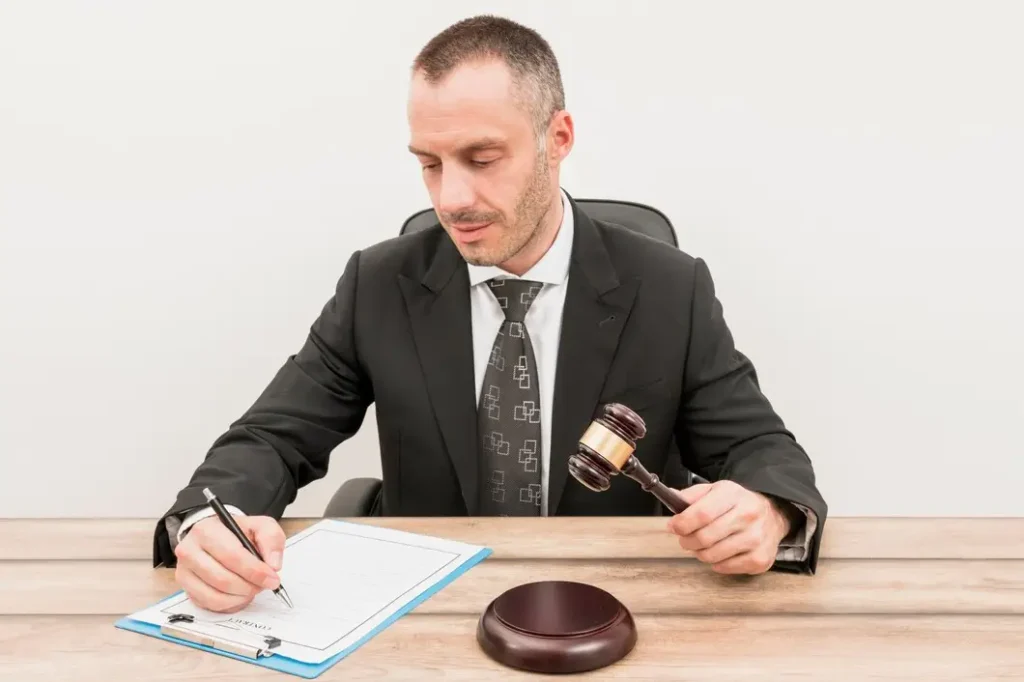Montopolis Man in a suit writing on a clipboard with a gavel, representing legal services for family law appeals in Montopolis.