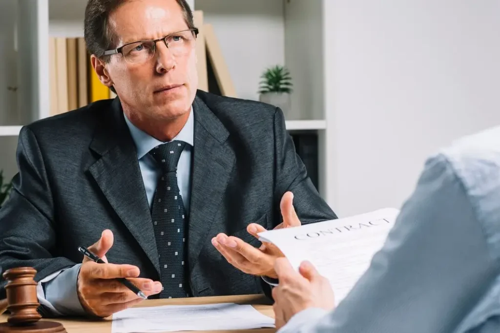Lawyer in a suit discussing a contract with a client, emphasizing legal representation and family law appeals in Old West Austin.