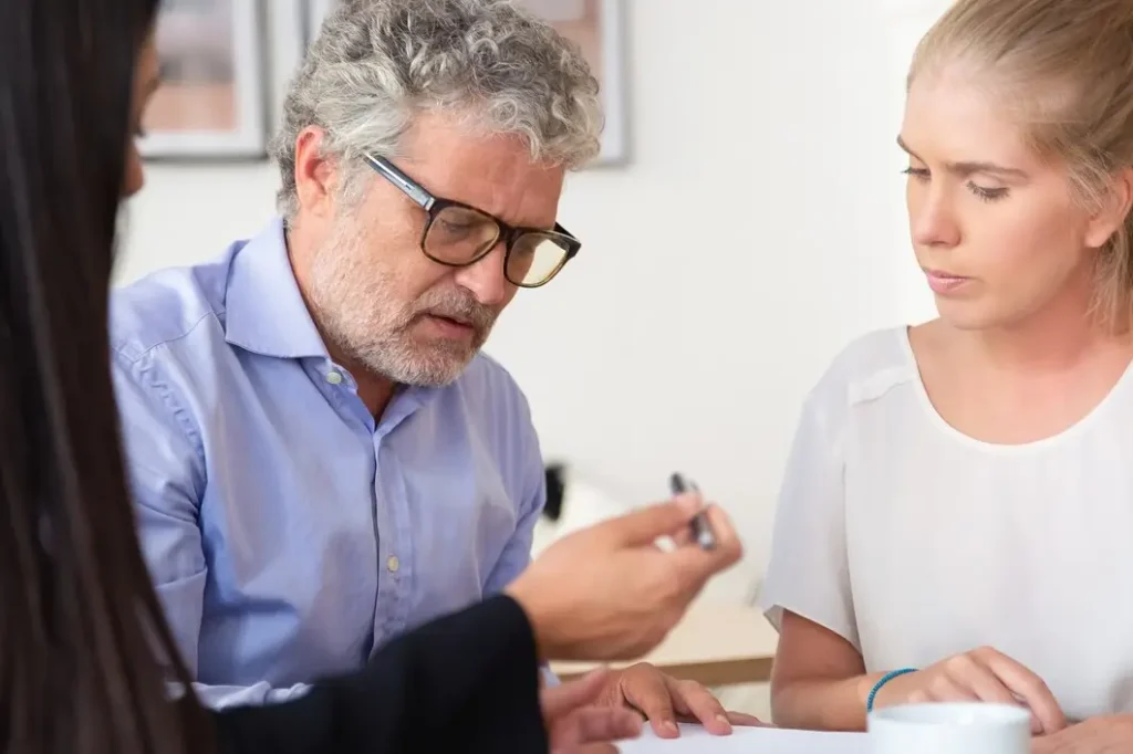 Lawyer consulting with clients about family law appeals, discussing legal documents and strategies in a professional setting.