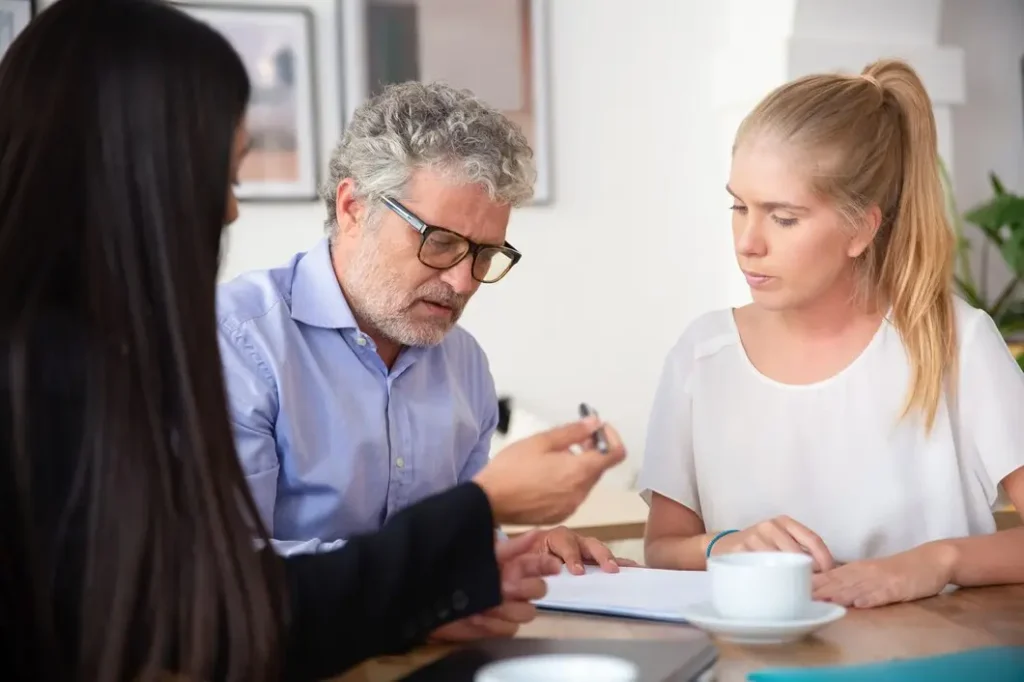 People consulting with a family law attorney, discussing legal documents related to family court appeals in a professional setting.