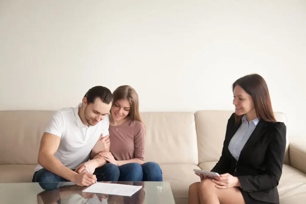 Couple signing legal documents with family law attorney in Tarrant County, Texas, emphasizing legal assistance for family court appeals.