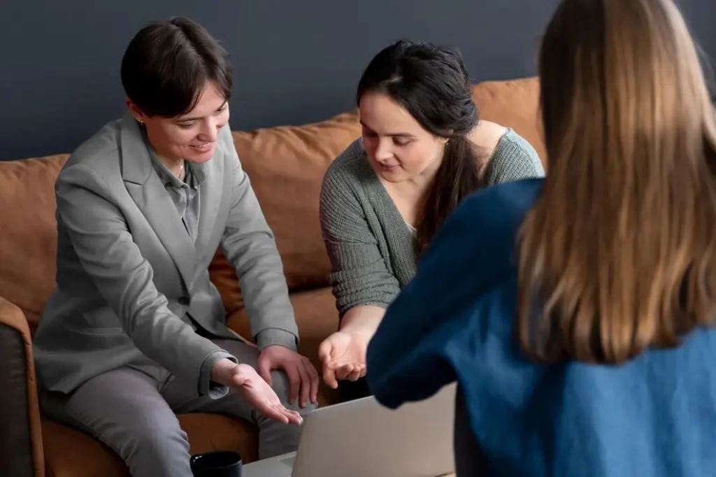 Individuals discussing family law appeals while reviewing documents on a laptop in a cozy setting, representing Bryan Fagan's legal services in Walnut Creek.