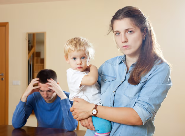 Mother holding child with serious expression, father in background showing signs of stress, illustrating family law issues and emotional challenges in custody disputes.