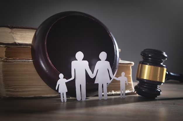 Paper cutout family holding hands in front of a gavel and law books, symbolizing family law appeals and legal representation in Brazoria County.