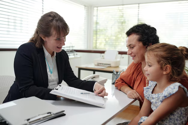 Woman in a professional setting discussing documents with a mother and daughter, emphasizing family law consultation and support in Shavano Park.