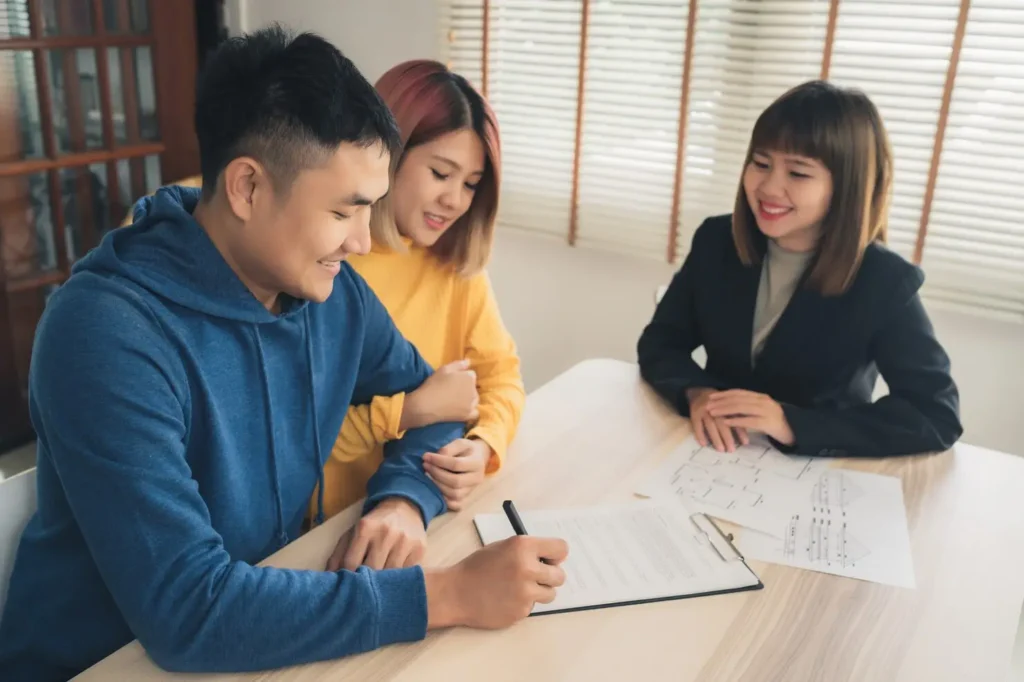 Couple consulting with a lawyer about property division during divorce, discussing legal documents and options for appeals in Texas.